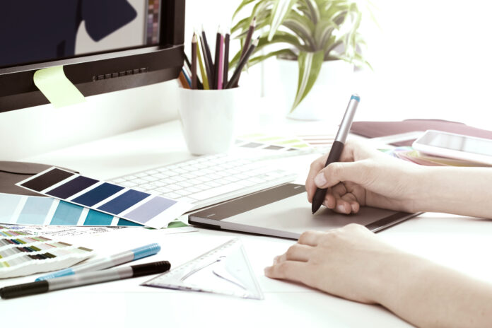 Graphic designer at work. Color samples.